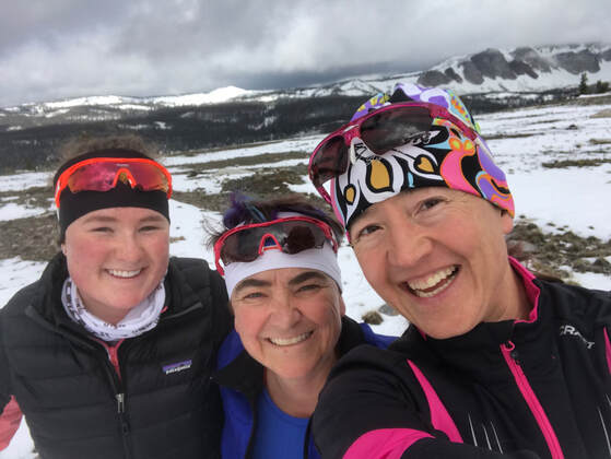 Syd, Christi, & Rachel selfie in front of Medicine Bow Peak in the snow.